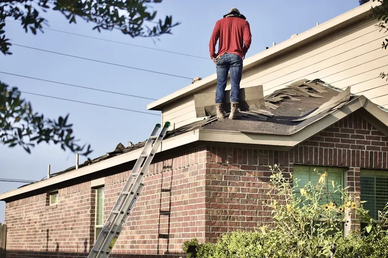 Professional roofer working on a residential roof in Bangor Base